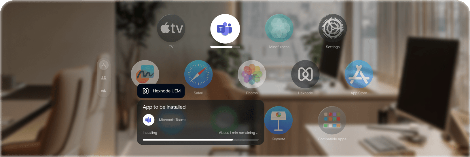 A Vision Pro showing an app grid and a notification for 'Microsoft Teams' installation with a progress bar, overlaid on a blurred office setting.